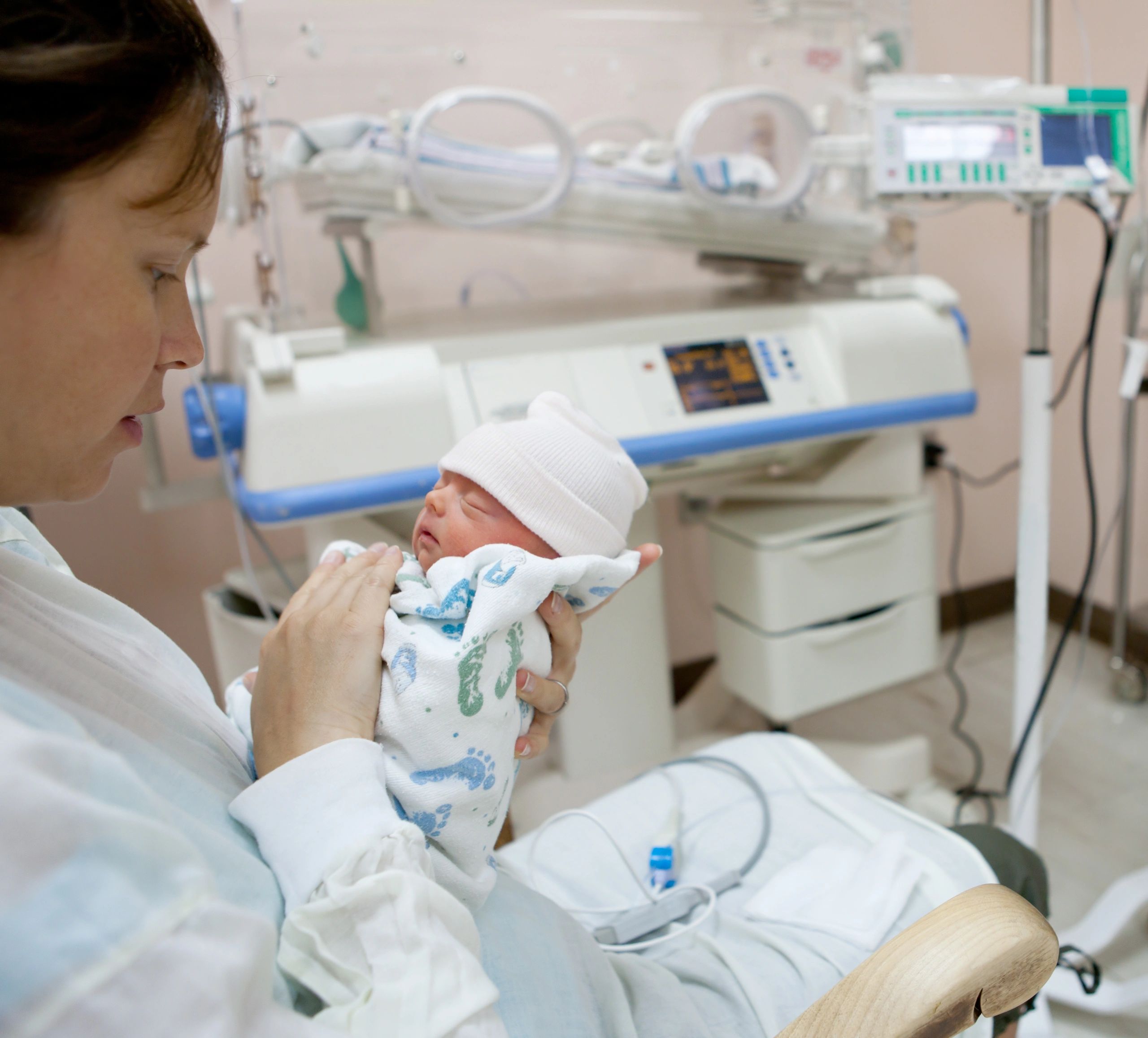 Mother holding a premature baby